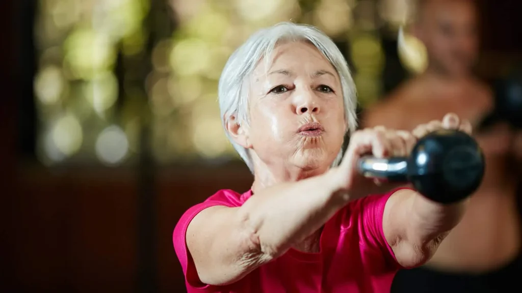 Toning Arms Without the Bulk: Is It Achievable? 1 Woman doing resistance band exercises for toned arms Tetbury